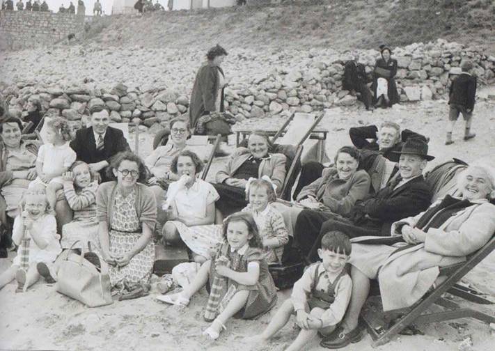 a family enjoying a picnic at the beach in Porthcawl